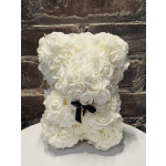 White rose-shaped teddy bear with a black ribbon bow