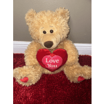 Teddy bear holding a red heart that says "Love You"