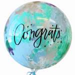 Clear balloon with colorful abstract print and the word Congrats