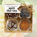 Box of decorated milk chocolates tied with a gold ribbon