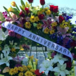 Large floral wreath with a "Happy Anniversary" ribbon