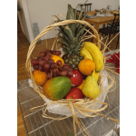 Fruit basket with pineapple, bananas, grapes, mangoes, pears, and apples