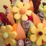 Fruit bouquet with carved pineapple flowers and chocolate-covered strawberries