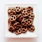 Square box filled with chocolate-covered pretzels