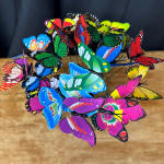 Cluster of colorful decorative butterflies on thin wires