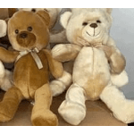 Two plush teddy bears with ribbons sitting side by side