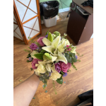 Handheld bouquet of white lilies, pink roses, and purple flowers