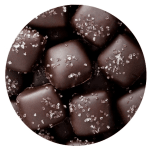 Round box of chocolate-covered candies topped with coarse salt