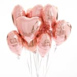 Cluster of rose gold heart-shaped balloons on thin strings