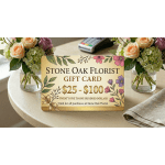Stone Oak Florist gift card on a table between two peach rose and hydrangea arrangements in glass vases