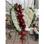 Heart-shaped standing spray of red roses and white flowers on an easel