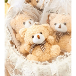 Three teddy bears wrapped in lace and clear plastic