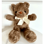 Brown teddy bear with a cream ribbon bow