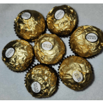Six Ferrero Rocher chocolates wrapped in gold foil