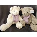 Two plush teddy bears with checkered bows on a dark backdrop