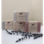 Stacked bars of goat milk soap with lavender sprigs in front