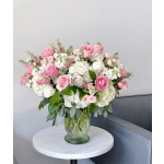 Pink and white rose bouquet in a glass vase