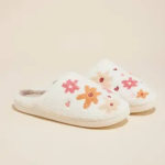 Pair of white slippers with colorful floral embroidery