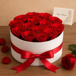 Round box of red roses with a red ribbon bow