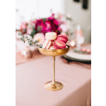 Gold pedestal dish filled with pink and white macarons