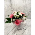 Pink and white flower arrangement in a small vase
