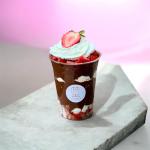 Chocolate dessert cup topped with whipped cream and strawberries