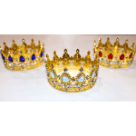 Three jeweled gold crowns on a white surface