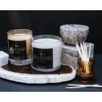 Two scented candles with matches in a small amber holder