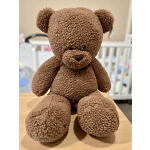 Brown plush teddy bear sitting on a table
