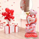 Red balloons beside white gift boxes and heart-shaped foil balloons with love messages