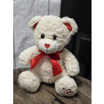 White teddy bear with a red ribbon and heart details