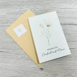 Sympathy card with a pale flower illustration and the words "Wishing You Comfort and Peace"