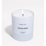 Lit white scented candle in a frosted glass jar