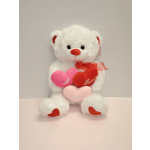 White teddy bear holding heart pillows