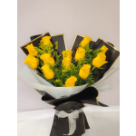 Bouquet of yellow roses wrapped in black and white paper