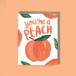 Greeting card with painted peaches and the phrase "you're a peach" on a peach-colored background.