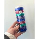 Hand holding a clear tube of foil-wrapped chocolate-covered cookies