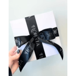 White gift box tied with a black satin ribbon