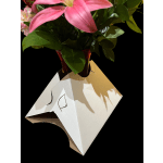 Pink lilies in a red vase with a white paper wrap