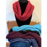 Knitted scarves in bright colors displayed on a mannequin