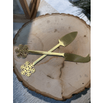 Gold snowflake cocktail picks on a wood slice