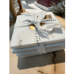Stacked white marble coasters tied with a ribbon