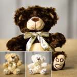 Plush teddy bears with ribbon bows, including one large brown bear and two smaller bears.