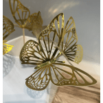 Gold butterfly decorations on clear sticks in a white container
