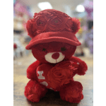 Red teddy bear wearing a red cap and floral accents