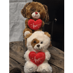 Two plush teddy bears holding red heart pillows with the word love.