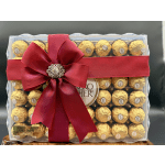Box of Ferrero Rocher chocolates tied with a red ribbon and bow