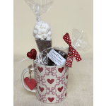 Gift mug filled with wrapped sweets and marshmallows, decorated with heart ribbons
