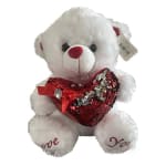 White teddy bear holding a red sequined heart