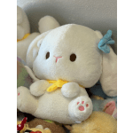 White plush bunny with a yellow ribbon and blue bow